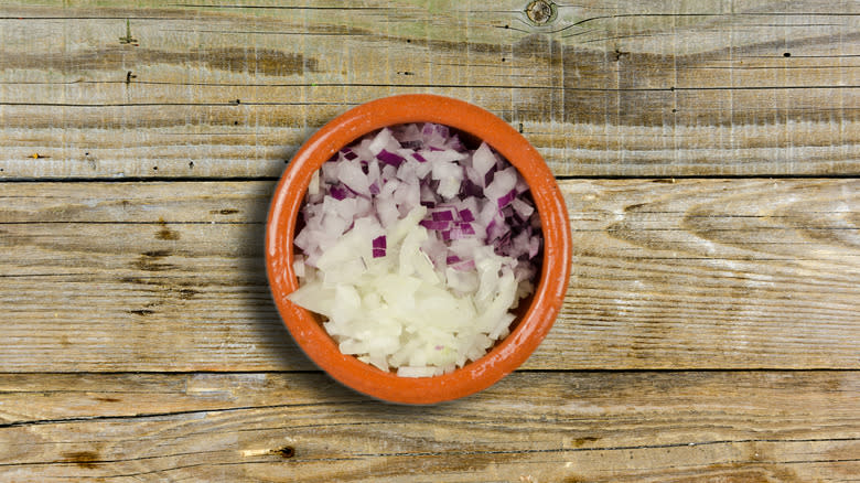 chopped onions in small clay bowl