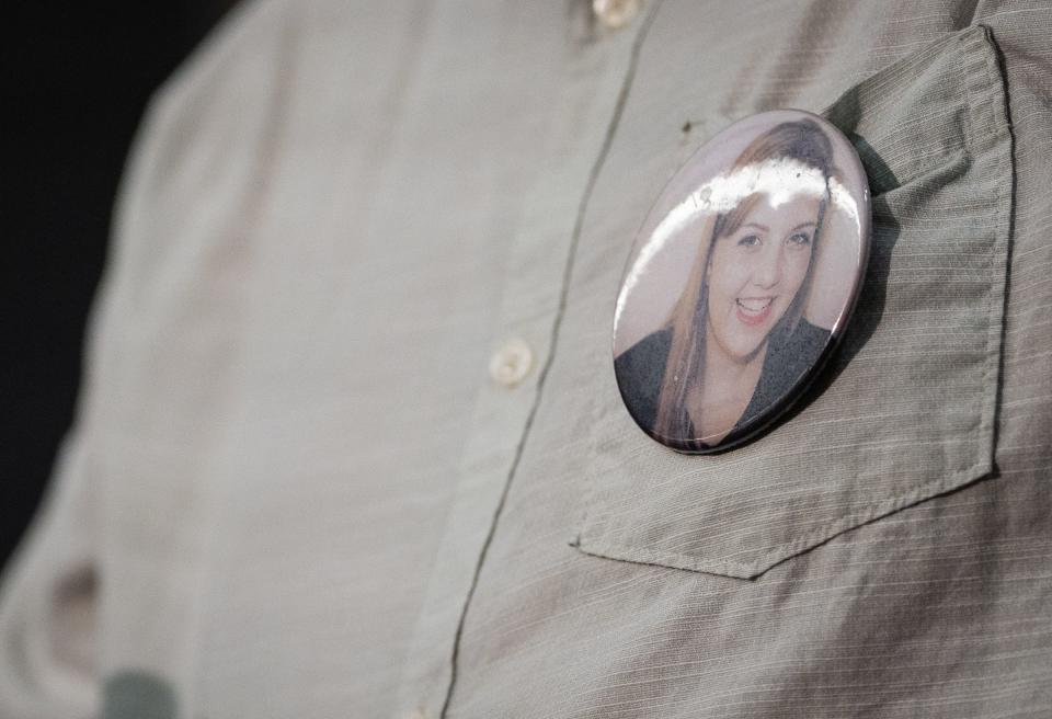 A button with the face of 19-year-old fire victim Haley Frizzell is worn Thursday by her father, Brian Frizzell. "Six or seven months ago, this sure seemed like it was ready to ... be a cold case forever," Brian Frizzell said.