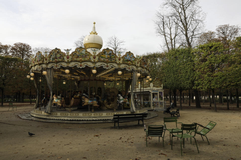 An empty carousel is pictured in the Tuileries gardens Wednesday, Oct.14, 2020 in Paris. French President Emmanuel Macron is giving a nationally televised interview Wednesday night to speak about the virus, his first in months. French media reports say Macron will also step up efforts on social media to press the need for virus protections among young people. (AP Photo/Lewis Joly)