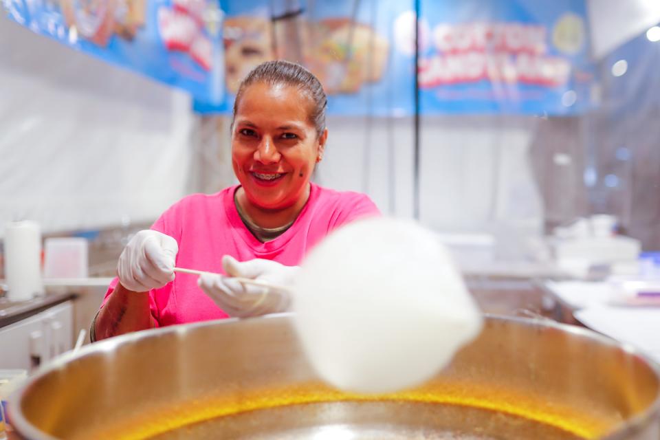 Giorgina Hernandez makes cotton candy at the 2023 Oklahoma State Fair in Oklahoma City.