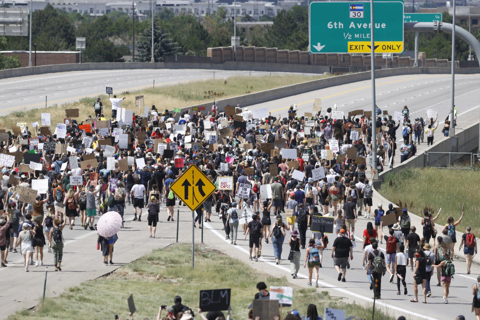 Demonstrators shut down Interstate 225 during a rally and march over the death of 23-year-old Elijah McClain, Saturday, June 27, 2020, in Aurora, Colo. McClain died in late August 2019 after he was stopped while walking to his apartment by three Aurora Police Department officers. (AP Photo/David Zalubowski)