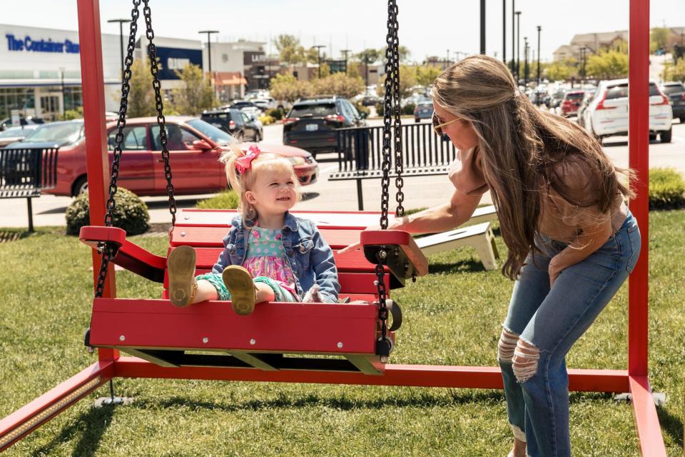 Visitors play at the Mi Casa, Your Casa 2.0 art installation in Cranston’s Garden City Center.