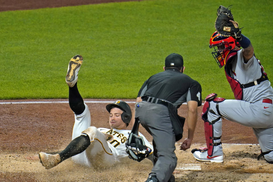 Pittsburgh Pirates' Bryan Reynolds, left, is tagged out by St. Louis Cardinals catcher Yadier Molina, right, with umpire Robert Ortiz preparing to make the call during the sixth inning of a baseball game in Pittsburgh, Thursday, Sept. 17, 2020. (AP Photo/Gene J. Puskar)