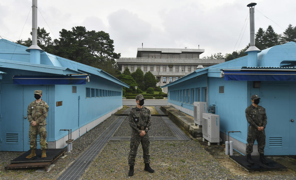 FILE - In this Sept. 16, 2020, file photo, U.S. and South Korean army soldiers stand guard during South Korean Unification Minister Lee In-young's visit to Panmunjom in the Demilitarized Zone, South Korea. A new agreement with South Korea on sharing the cost of keeping U.S. troops on the Korean peninsula is early evidence that President Joe Biden is shifting America's approach to alliances in Asia and beyond. It shows he will cut allies a break to build unity in competition against China and Russia. (Park Tae-hyun/Korea Pool via AP, File)