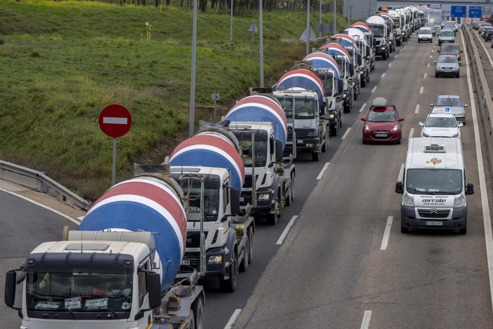 FILE - Trucks gather to protest against the high price of fuel in Parla, on outskirts of Madrid, Spain, on March 22, 2022. As food costs and fuel bills soar, inflation is plundering people’s wallets, sparking a wave of protests and workers’ strikes around the world. (AP Photo/Manu Fernandez)