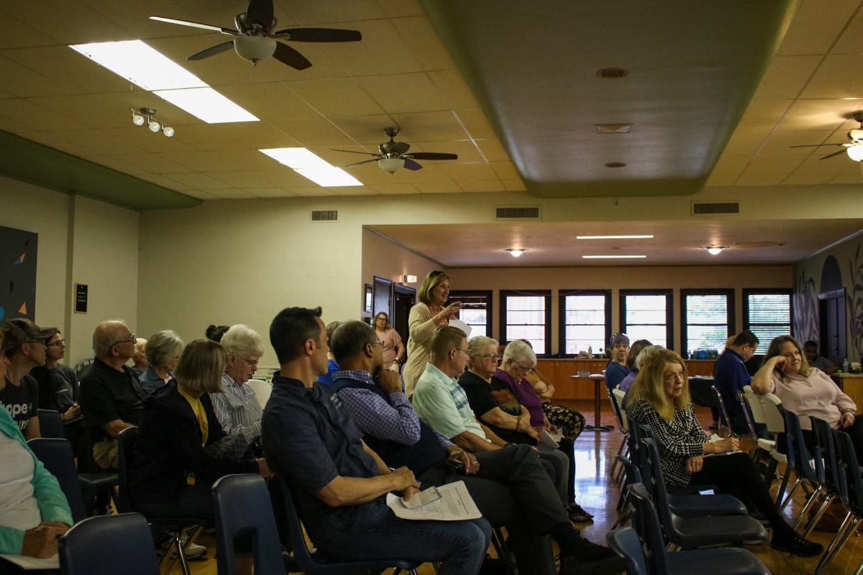 A community member speaks during a public forum at Salina Grace Resource Center.