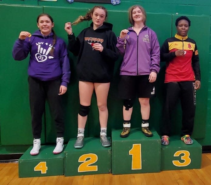 Canton junior Katelyn Marvel, second to the right, stands atop the podium following her 145-pound championship victory at the Geneseo Sectional on Saturday, Feb. 10.