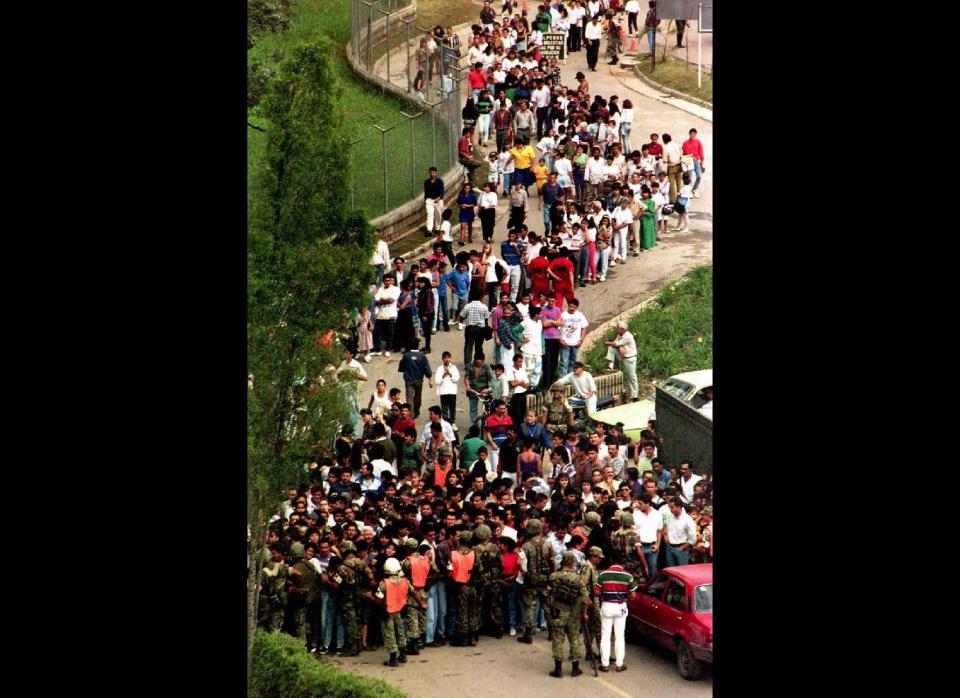 MEDELLEN, COLOMBIA:  Hundreds of people wait, 03 December 1993, outside the cemetery, where the body of Pablo Escobar is being viewed. Police estimated that some 20,000 people came for the viewing, one day after the drug lord was killed by a police-army elite force in Medellin, Colombia. (Photo credit should read ROBERTO SCHMIDT/AFP/Getty Images)