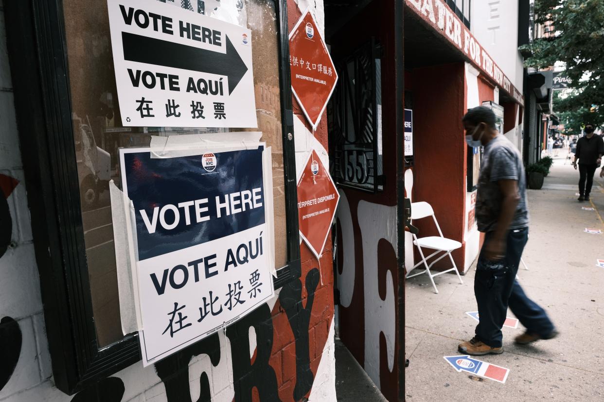 Signs alert people to a voting site in Manhattan as voters head to the polls for the Democratic primary for mayor and other elected positions on June 22, 2021, in New York City. Ranked-choice voting is being used for the first time, a system that lets voters prioritize more than one candidate on their ballot.  The winner of the Democratic primary will face off against the Republican candidate in the fall.