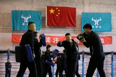 Trainees from Dewei Security attend boxing training at a training camp, on the outskirts of Beijing, China March 2, 2017. Picture taken March 2, 2017. To match Analysis CHINA-SILKROAD/SECURITY REUTERS/Jason Lee