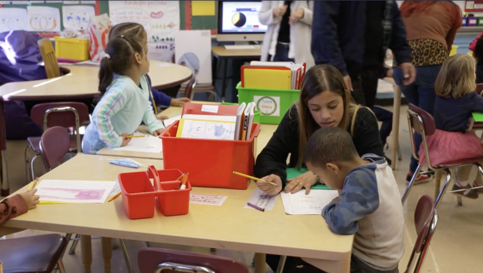 A teacher helps a student P.S. 145, a public school on New York City's Upper West Side. / Credit: CBS News