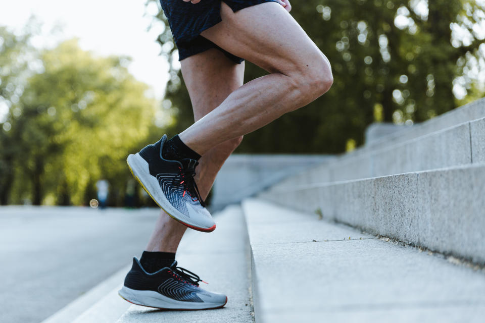 Man climbing steps in workout gear. (Getty Images)