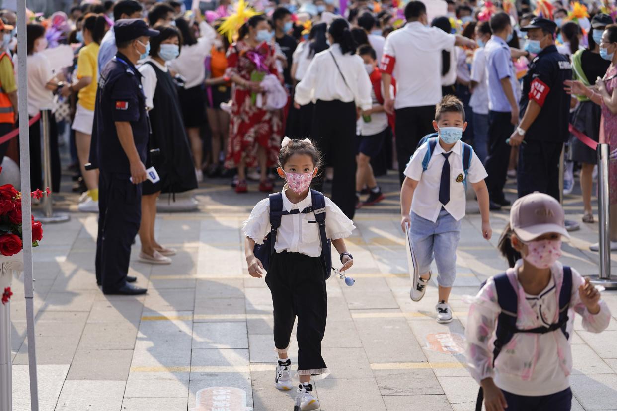 Elementary school students arrive at school on the first day of the new semester in Wuhan in China's central Hubei province on Sept. 1, 2020. Schools across the city, which was once the epicenter of the coronavirus pandemic, reopened for a new semester on Tuesday.