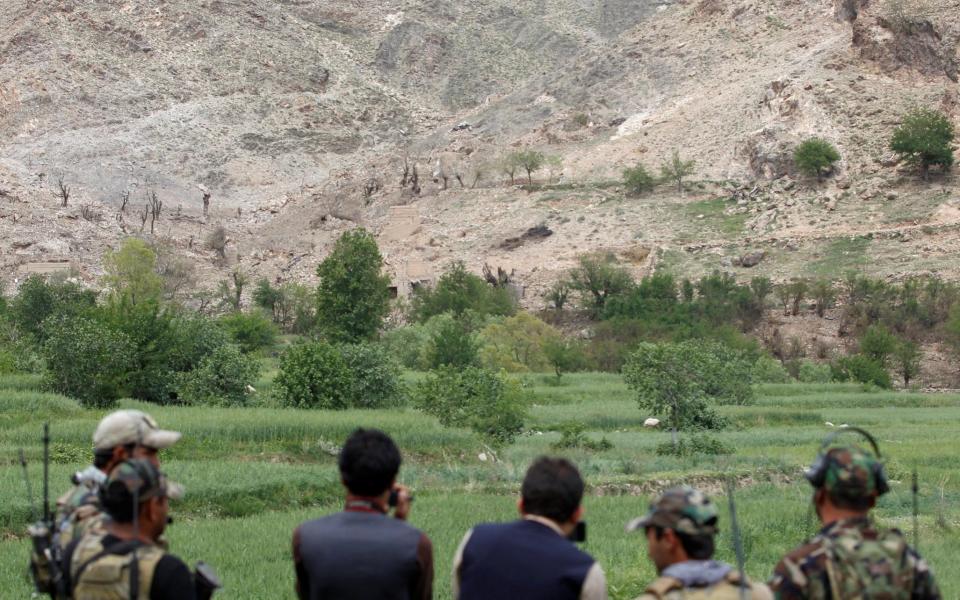 Afghan Special Forces watch at the site where a MOAB, or ''mother of all bombs'', struck the Achin district of the eastern province of Nangarhar, Afghanistan April 23, 2017. - Credit: Parwiz/Reuters