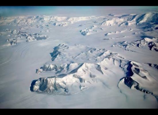 Liv Glacier flows for 45 miles from the polar plateau through the Transantarctic Mountains to the Ross Ice Shelf in the foreground.  Byrd’s flight to the South Pole followed the left (east) side of the glacier.  Mt. Fridtjof Nansen is the highest peak on the horizon to the east (left) of Liv Glacier.