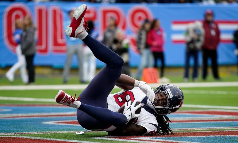Houston Texans wide receiver Noah Brown (85) lands in the end zone for a touchdown against the Tennessee Titans during the fourth quarter at Nissan Stadium in Nashville, Tenn., Sunday, Dec. 17, 2023.