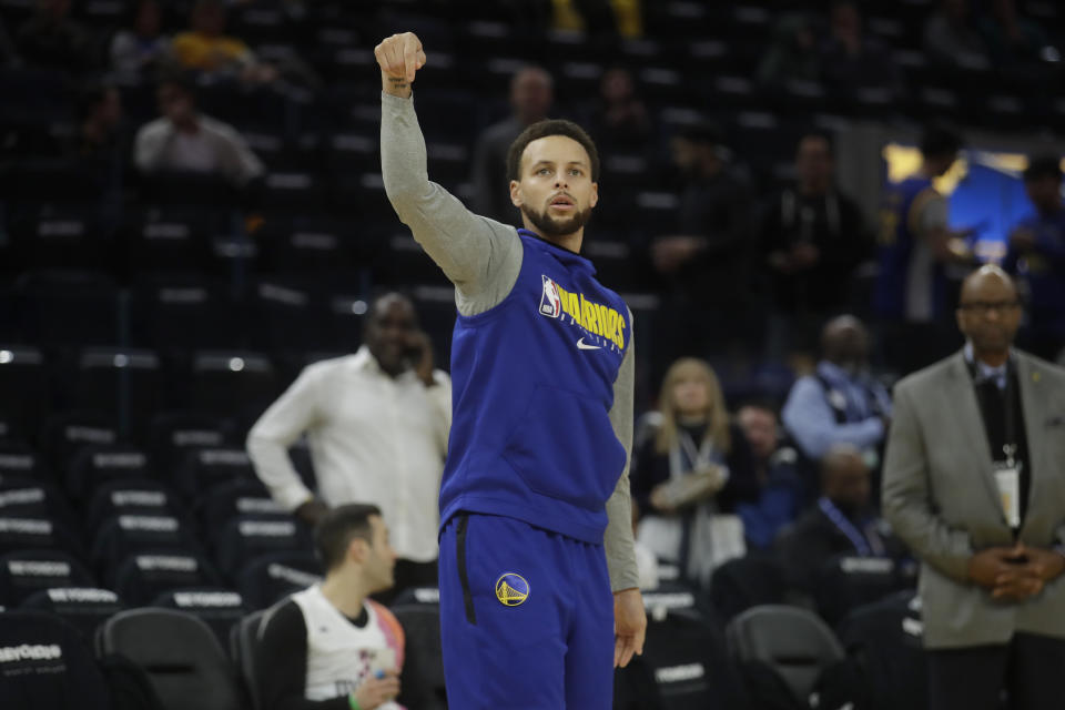 Injured Golden State Warriors guard Stephen Curry shoots before an NBA basketball game between the Warriors and the Miami Heat in San Francisco, Monday, Feb. 10, 2020. (AP Photo/Jeff Chiu)