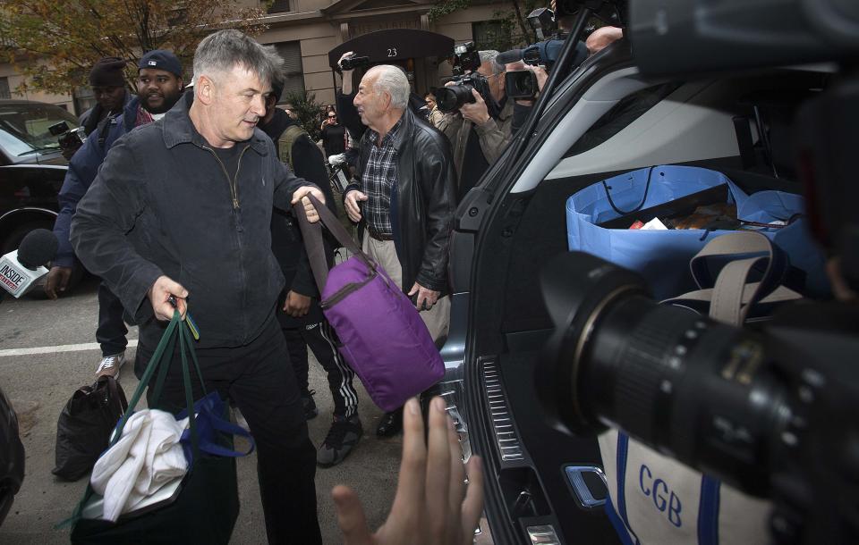 Actor Alec Baldwin loads bags into his SUV outside his apartment in New York