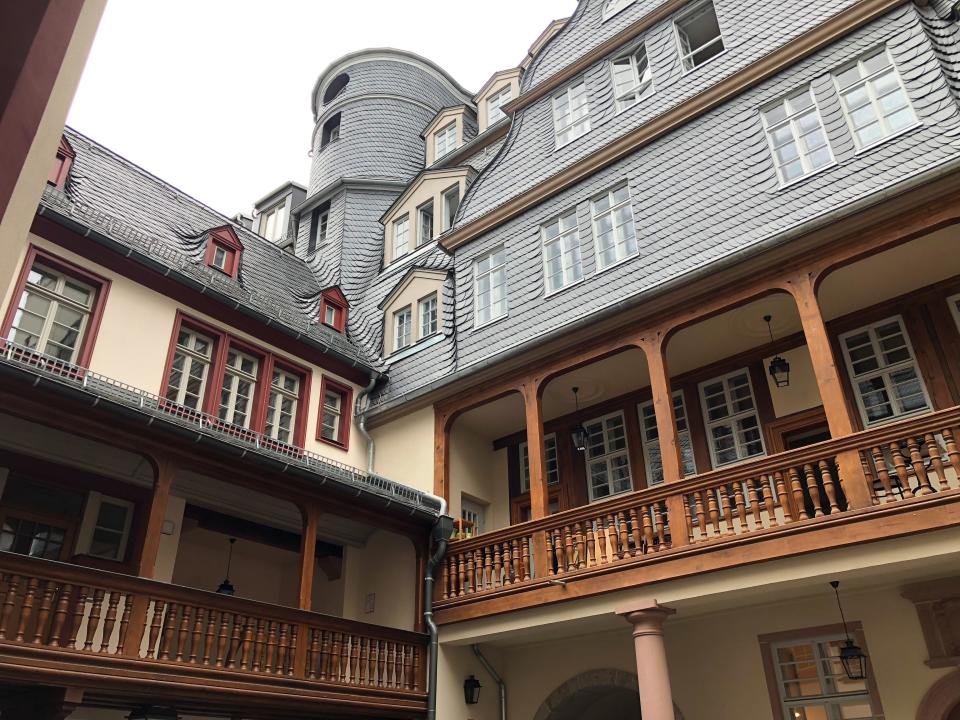 A courtyard of multiple buildings reconstructed in the original style that now house local residents who purchased the apartments through a lottery four years ago.