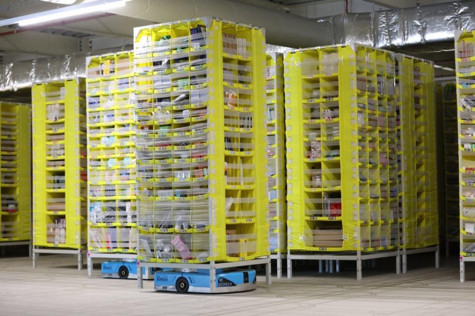 SUTTON COLDFIELD, ENGLAND - DECEMBER 19: A robot brings a pallet of items to employees for sorting at Amazon's Robotic Fulfillment Centre on December 19, 2023 in Sutton Coldfield, England. Launched in October, the 24/7 fulfillment center, equipped with cutting-edge robotics for sorting, packing, and shipping millions of items, has already employed 1,400 staff, as well as additional hires for the Christmas period. (Photo by Nathan Stirk/Getty Images)