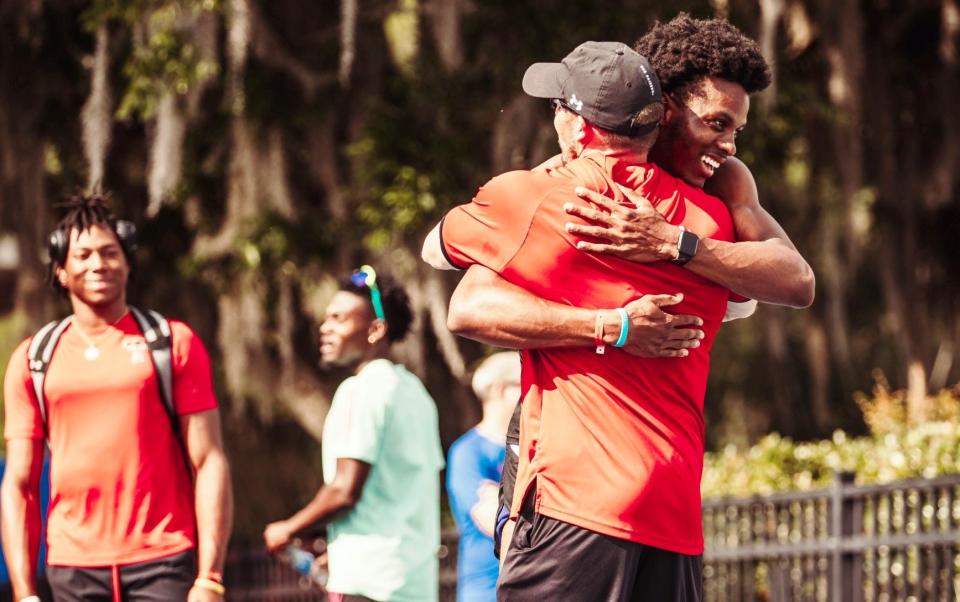 Texas Tech sprinter Terrence Jones embraces IVC grad and Tech assistant coach Zach Glavash on the track.