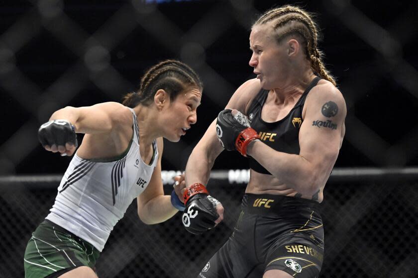 Alexa Grasso, left, and Valentina Shevchenko battle in a UFC 285 mixed martial arts flyweight title bout Saturday, March 4, 2023, in Las Vegas. (AP Photo/David Becker)