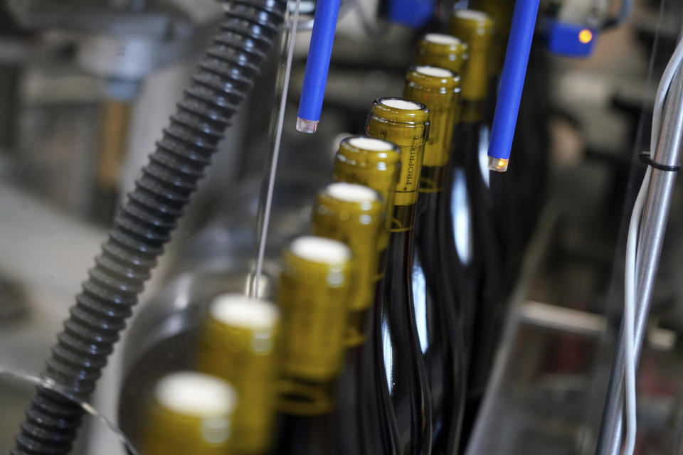 In this photo taken on Tuesday, Nov 12, 2019, bottles of wine are pictured in the Vinescence cellar in Saint Jean d'Ardieres, in the Beaujolais region, eastern France, Celebration is the mot du jour in France’s Beaujolais region on the third Thursday of November, when winemakers and sellers uncork the season’s Beaujolais Nouveau with feasting and fanfare. (AP Photo/Laurent Cipriani)