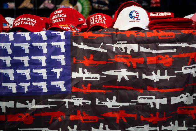 Hand gun- and rifle-themed American flags, hats and other MAGA gear is sold during the ReAwaken America Tour. (Photo: Photo by Jabin Botsford/The Washington Post via Getty Images)