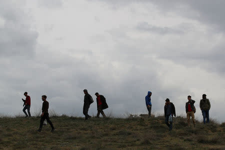 A group of Afghan migrants walk along a path on mountains after crossing the Turkey-Iran border near Erzurum, eastern Turkey, April 12, 2018. Picture taken April 12, 2018. REUTERS/Umit Bektas
