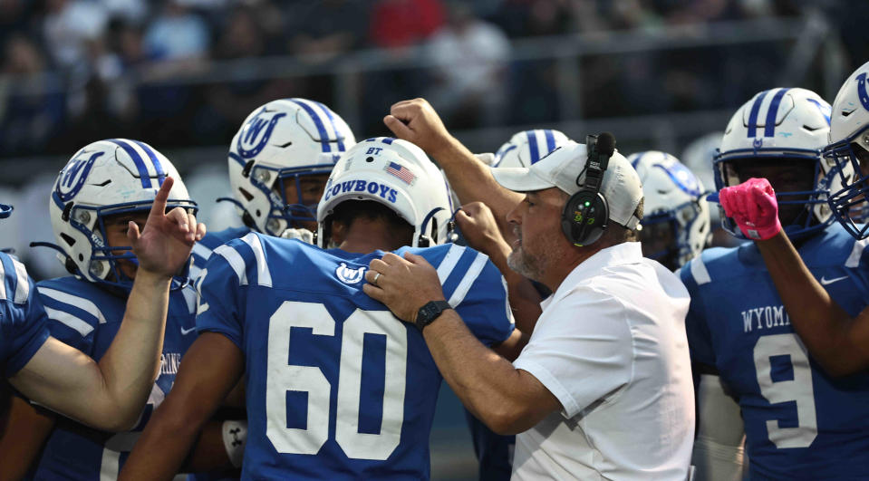 Wyoming coach Aaron Hancock talks to his players before their football game against Indian Hill, Friday, Oct. 13, 2023.