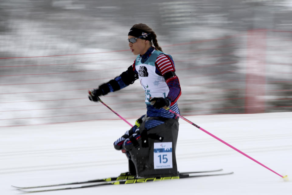 FILE - Oksana Masters, of the United States, on her way to a silver medal in the Biathlon Women's 12.5km Sitting event during the 2018 Winter Paralympics at the Alpensia Biathlon Centre in Pyeongchang, South Korea, March 16, 2018. Masters credits resiliency, determination and being headstrong for what she is today -- an eight-time Paralympic medalist. Masters persevered through 7 1/2 years in Ukrainian orphanages and with birth defects believed to be the aftermath of Chernobyl, the world's worst nuclear accident. That malnourished orphan eventually was adopted by her American mom. She will compete at the Paralympics in Tokyo in road cycling this week. In six months, she also plans to defend her cross-country skiing Paralympic titles in Beijing. (AP Photo/Ng Han Guan, file)