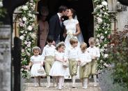 <p>Pippa Middleton and James Matthews kiss beneath an arch of flowers at St Mark's Church after <a href="https://www.townandcountrymag.com/the-scene/weddings/g9899242/pippa-middleton-wedding-pictures/" rel="nofollow noopener" target="_blank" data-ylk="slk:their wedding ceremony;elm:context_link;itc:0;sec:content-canvas" class="link ">their wedding ceremony</a>. Leading the procession are their page boys and bridesmaids, including Prince George and Princess Charlotte. </p>