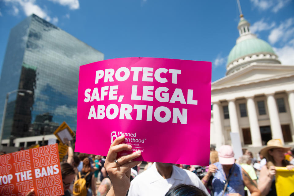 Protesters hold signs as they rally in support of Planned Parenthood and pro-choice and to protest a state decision that would effectively halt abortions by revoking the center's license to perform the procedure, near the Old Courthouse in St. Louis, Missouri, May 30, 2019. (Photo by SAUL LOEB / AFP)        (Photo credit should read SAUL LOEB/AFP/Getty Images)