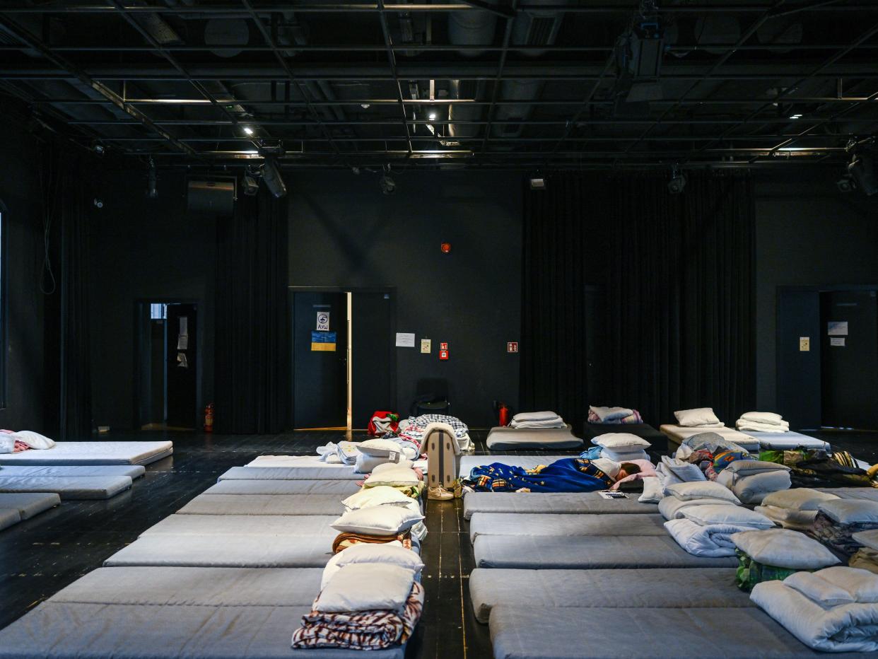 A woman who fled the war in Ukraine rests in a temporary shelter at the House of Theater Craft on March 31, 2022 in Krakow, Poland.