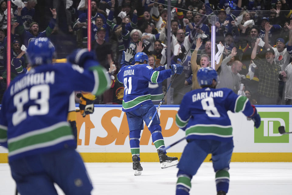 Vancouver Canucks center Dakota Joshua (81) celebrate his goal against the Nashville Predators as teammates Elias Lindholm (23) and Conor Garland (8) skate towards him during the third period in Game 1 of an NHL hockey Stanley Cup first-round playoff series in Vancouver, British Columbia, on Sunday, April 21, 2024. (Darryl Dyck/The Canadian Press via AP)