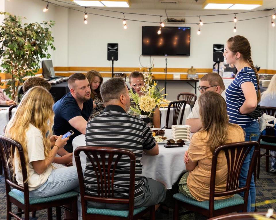 Relatives of one of the Opportunity Kitchen graduates, Alix Rhoads, try the dessert she made before her graduation ceremony.