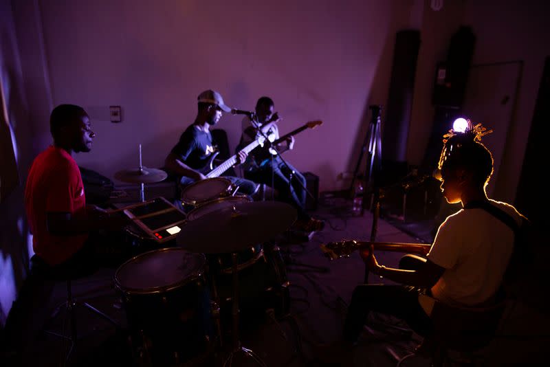 Congolese singer Celine Banza strums a guitar at a band practice studio in the French Institute in central Kinshasa