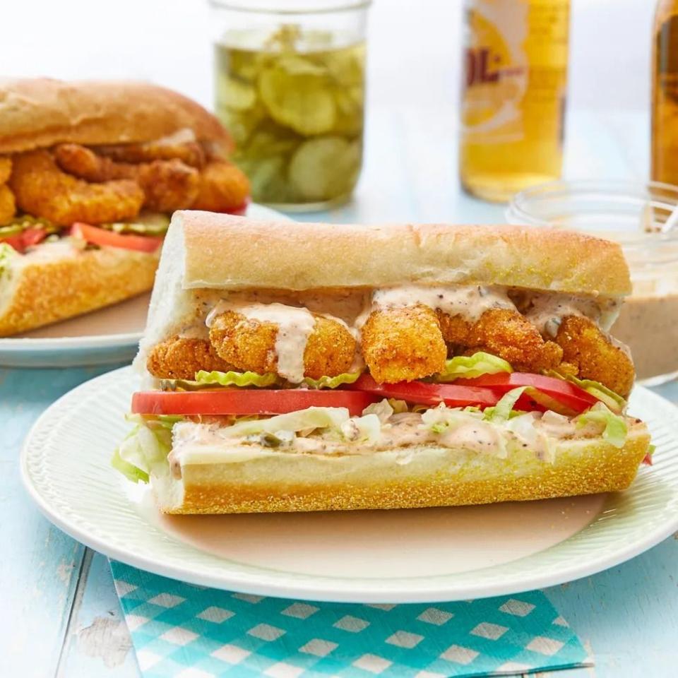 shrimp poboy with tomatoes and mayo on baguette
