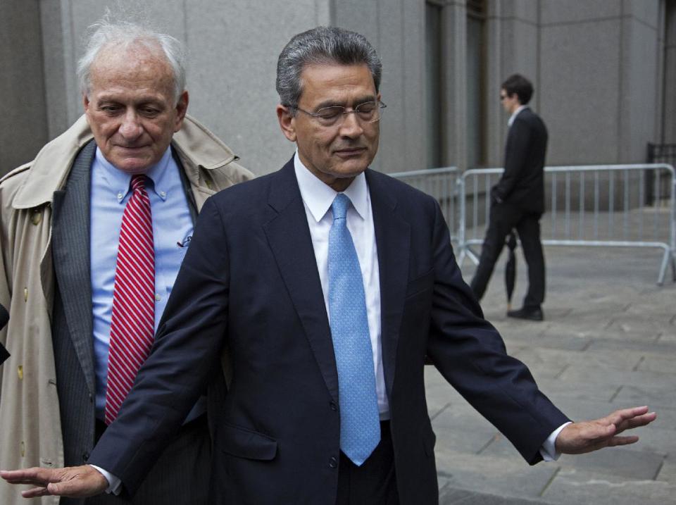 Rajat Gupta, right, declines to answer questions as he leaves federal court in New York, Wednesday, Oct. 24, 2012 after the former Goldman Sachs and Procter & Gamble Co. board member was sentenced Wednesday to 2 years in prison for feeding inside information about board dealings with a billionaire hedge fund owner who was his friend. Left is Gupta's attorney Gary Naftalis. (AP Photo/Craig Ruttle)