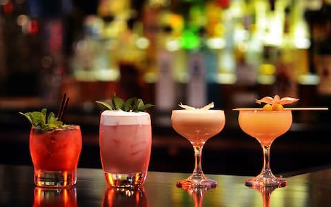 Craft Cocktail Assortment on Well Lit Bar - Credit: Katie Sik/Getty Images