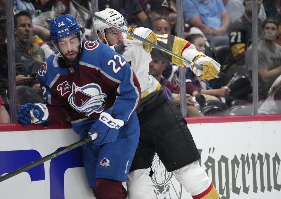 Vegas Golden Knights center Nicolas Roy, right, cheks Colorado Avalanche defenseman Conor Timmins during the first period of Game 5 of an NHL hockey Stanley Cup second-round playoff series Tuesday, June 8, 2021, in Denver. (AP Photo/David Zalubowski)