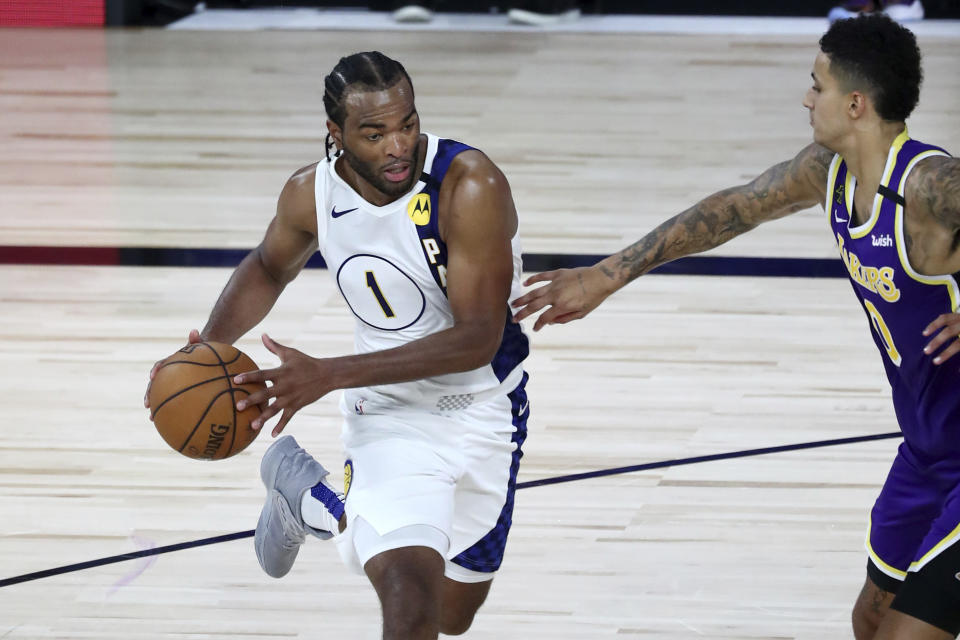 Indiana Pacers forward T.J. Warren (1) drives to the basket against Los Angeles Lakers forward Kyle Kuzma (0) during the third quarter of an NBA basketball game Saturday, Aug. 8, 2020, in Lake Buena Vista, Fla. (Kim Klement/Pool Photo via AP)