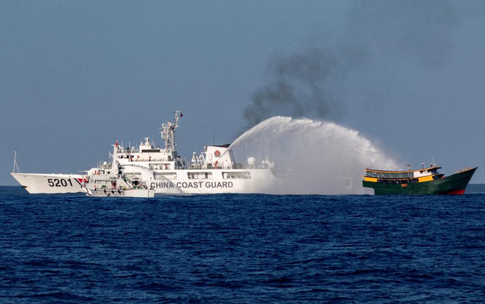 Chinese Coast Guard vessels fire water cannons towards a Philippine resupply vessel in the South China Sea in March