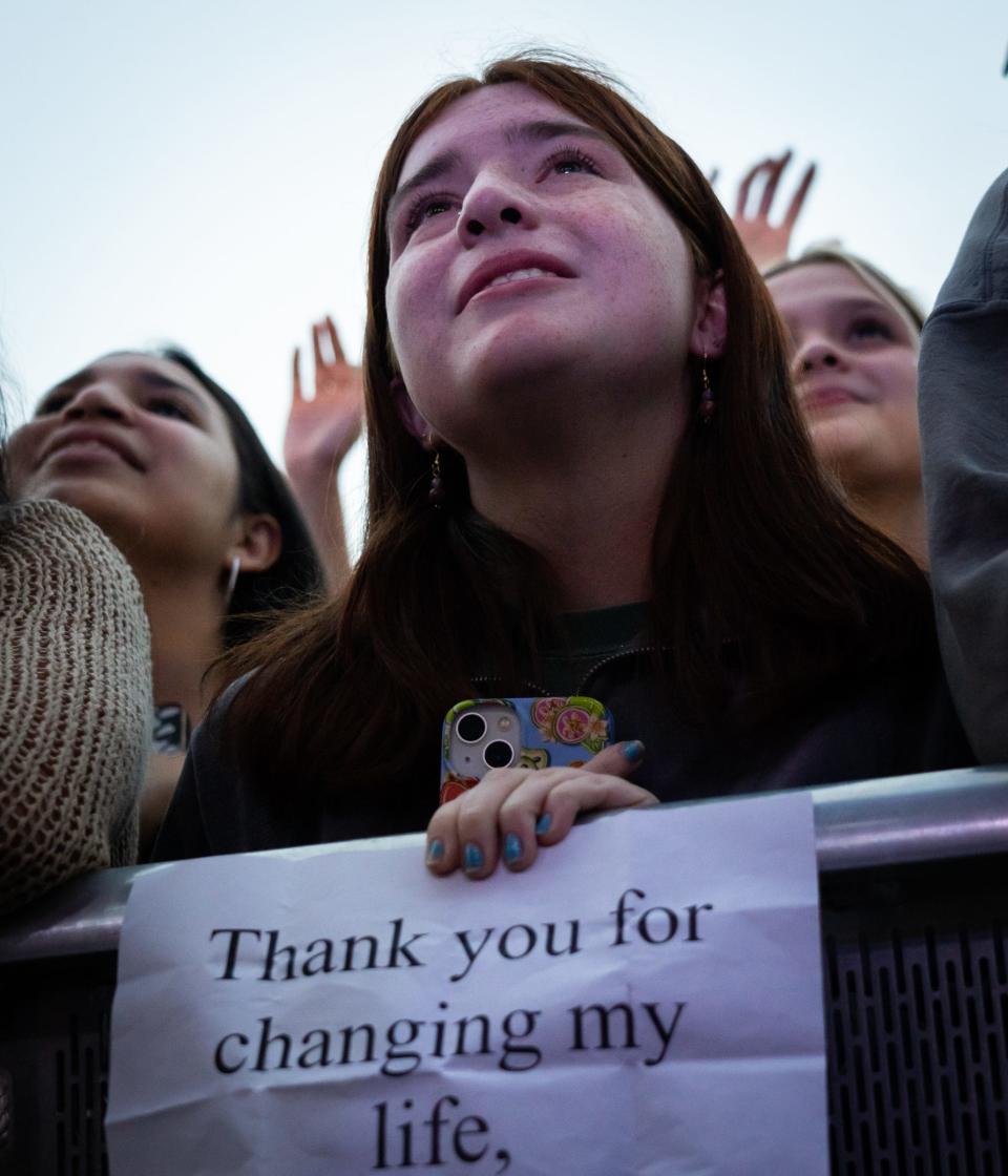 A fan watches Noah Kahan perform Saturday at ACL Fest.