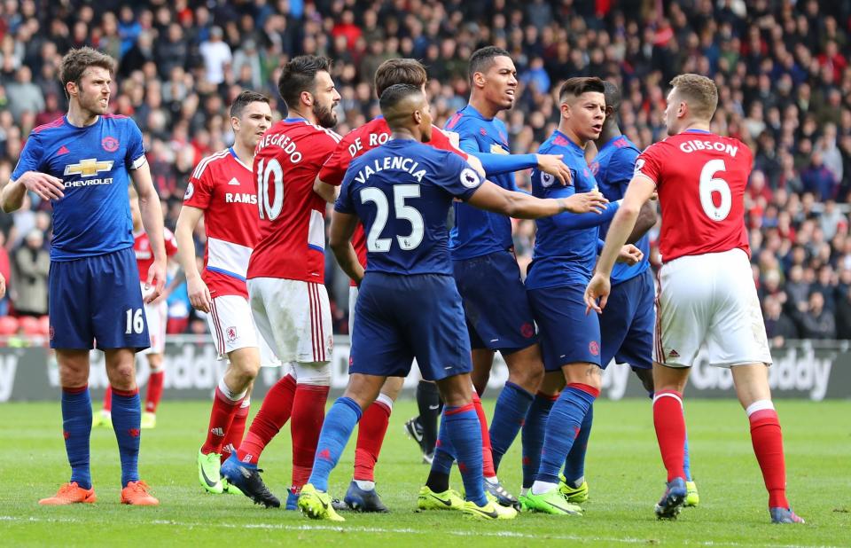 <p>United and Boro players come together after a heated exchange </p>