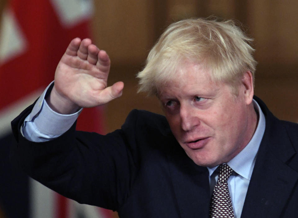 Britain's Prime Minister Boris Johnson reacts during a virtual press conference at Downing Street in London, Wednesday Sept. 9, 2020, following the announcement that the legal limit on social gatherings is set to be reduced from 30 people to six. The change in England will come into force on upcoming Monday as the Government seeks to curb a recent ongoing rise in coronavirus cases. (Stefan Rousseau/Pool via AP)