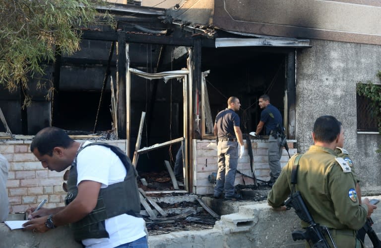 Israeli security forces inspect a Palestinian house burned down in the suspected arson attack by Jewish settlers in the West Bank village of Duma on July 31, 2015