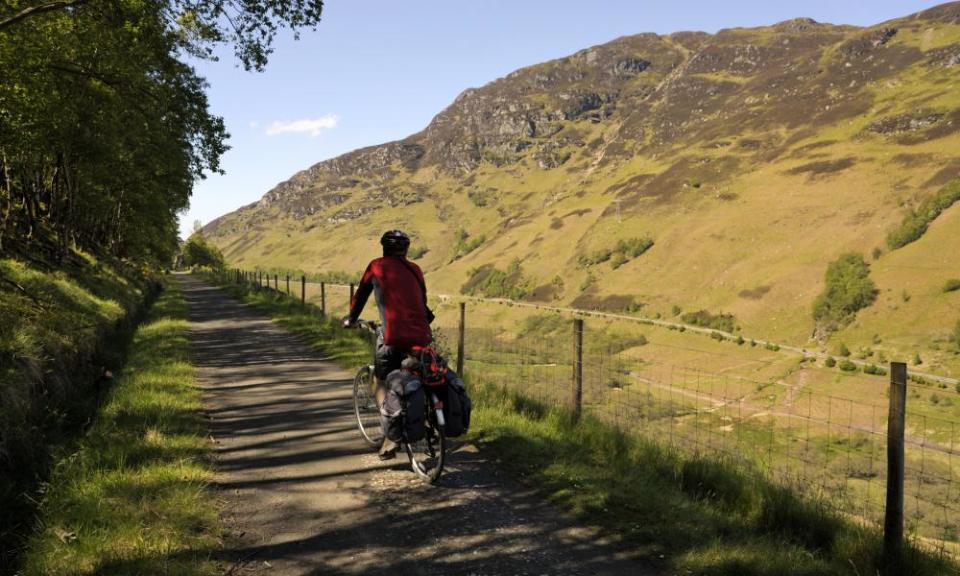Cyclist on Sustrans cycling route 7, a former railway line, at Glen Ogle, Scotland