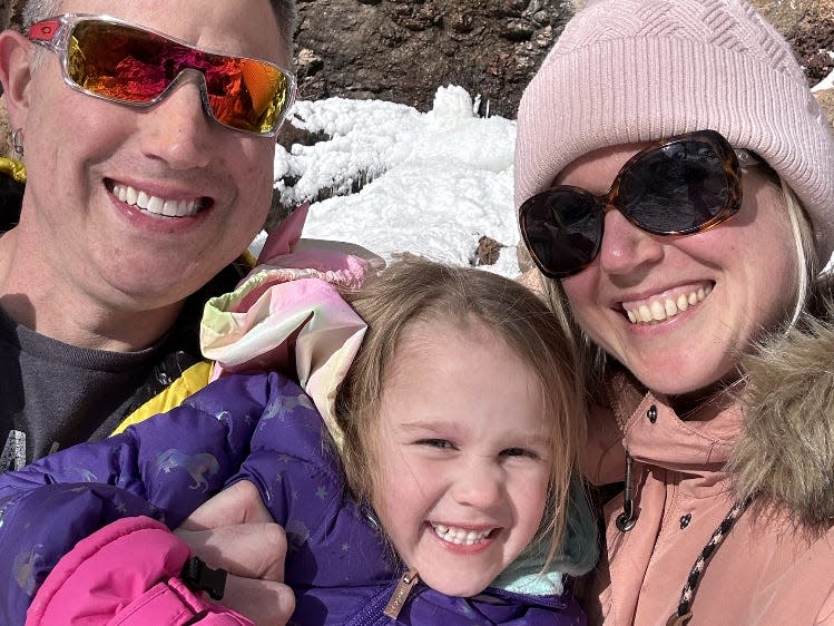 Andrew Robertson poses with his half-sister, Meghan Thomas, and his daughter, Alana. They are wearing ski outfits.