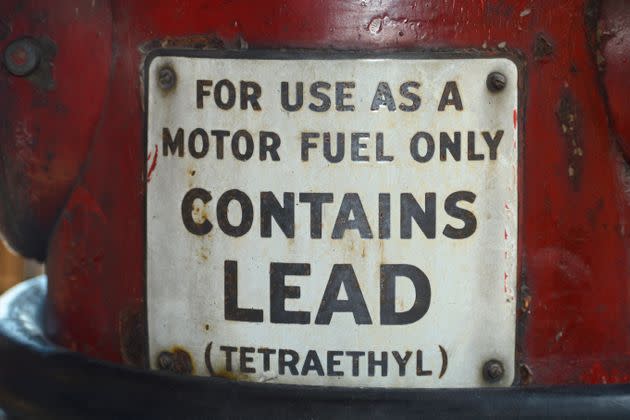 A sign on a vintage gasoline pump advises that the gas contains lead (tetraethyl).  (Photo: Robert Alexander via Getty Images)